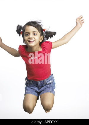 South Asian Indian girl jumping with joy in nursery school MR Stock Photo