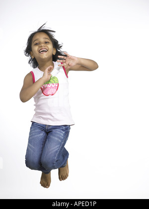 South Asian Indian girl jumping with joy in nursery school MR Stock Photo