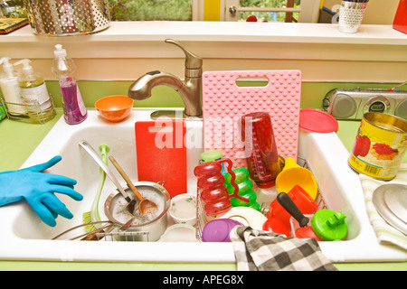 Sink filled with dirty dishes Stock Photo
