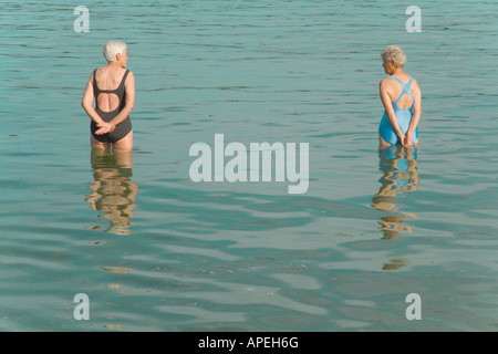 Senior women standing in water