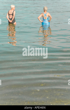 Senior women standing in water