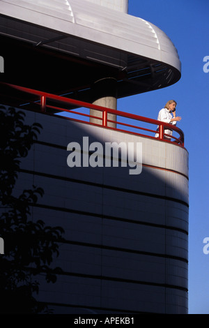 Executive talking with cell phone on balcony Stock Photo