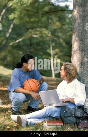 College life. a college students between classes on the campus grounds ...