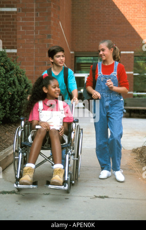 Handicapped girl is helped by friends. Stock Photo
