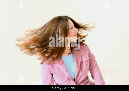 Young woman shaking her head and hair.  MODEL RELEASED. Stock Photo