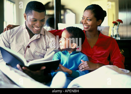 Family reading together in bed. Stock Photo