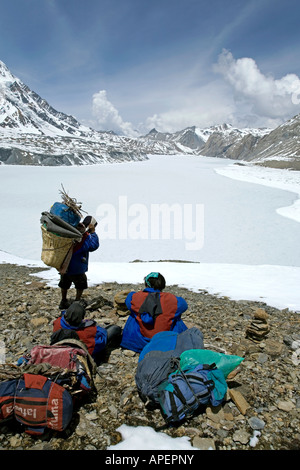 Trekkers resting at Tilicho Lake. Highest Lake in the World (4919m). Annapurna circuit trek. Nepal Stock Photo