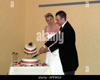 Wedding Reception at the Bull Hotel Peterborough England Bride and Groom Cutting the Cake Stock Photo