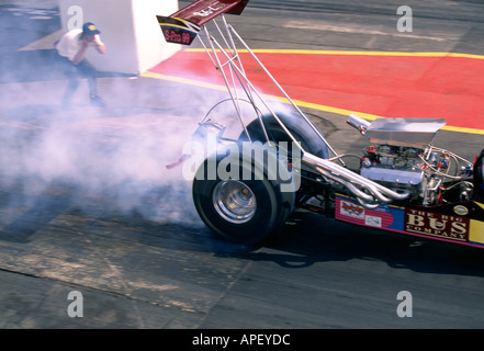 Drag car at starting line, wheelspin and smoke Stock Photo - Alamy
