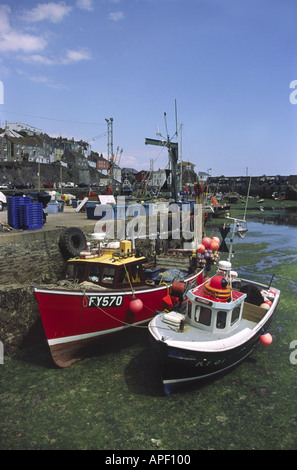 Moored fishing boats Mevagissey Inner Harbour at Low Tide Cornwall England Stock Photo