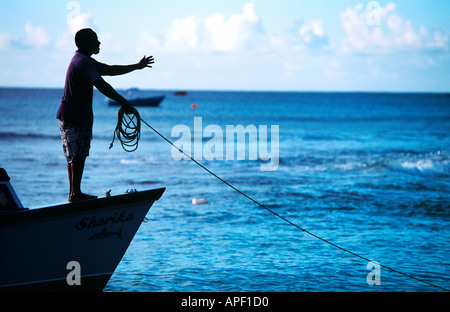 Bringing the boat to shore at sunset Barbados Stock Photo