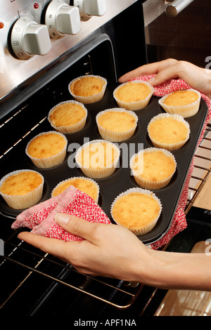 WOMAN IN KITCHEN BAKING CAKES Stock Photo