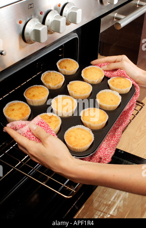 WOMAN IN KITCHEN BAKING CAKES Stock Photo