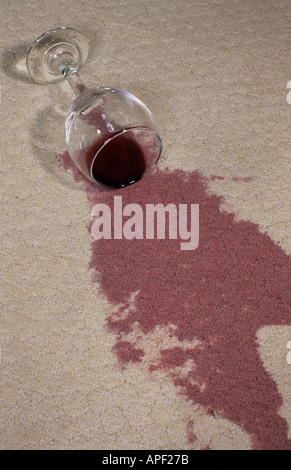 red wine spilt on white lounge carpet Stock Photo
