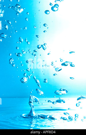 air bubbles water jet gets through water surface picture is turned by 180 degrees Stock Photo