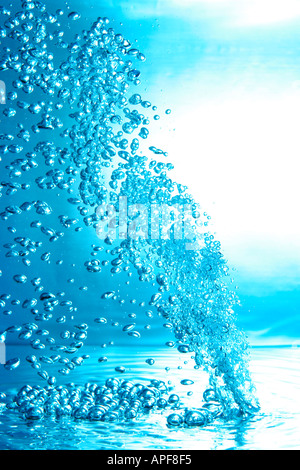 air bubbles water jet gets through water surface picture is turned by 180 degrees Stock Photo