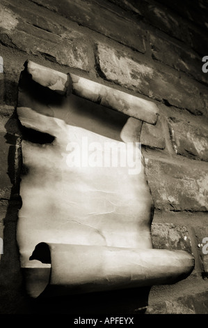 Old parchment on a brick wall Stock Photo