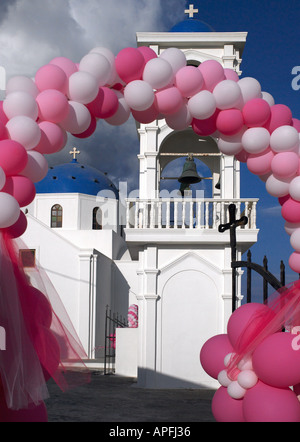 Ribbon of balloons around a Greek Orthodox Church gate for a traditional wedding on the Greek island of Santorini Stock Photo