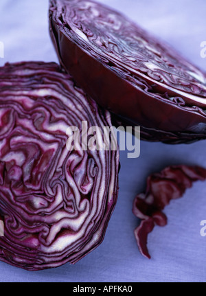 Red cabbage cut in half on pale linen background Stock Photo