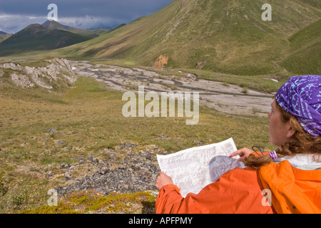 alaska arctic national wildlife refuge woman reading map looking up valley Stock Photo