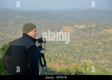 A photographer on Cherohala Skyway in Tennessee USA enjoys a crisp autumn day for digital photography.. Stock Photo