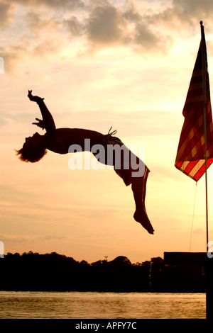 Man diving backwards from pier, Florida, NICK JULZ HEANEY Stock Photo
