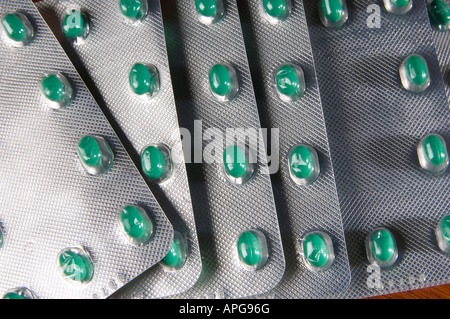 Green medical pills packed in foil Stock Photo