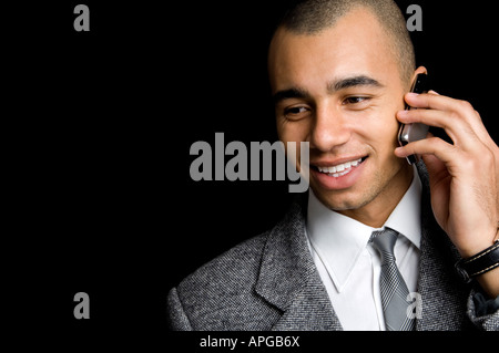 young mixed race businessman chatting on a mobile phone Stock Photo