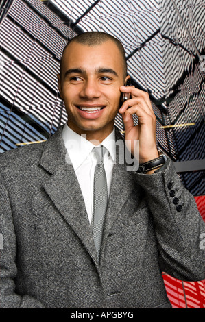 young mixed race businessman chatting on a mobile phone Stock Photo