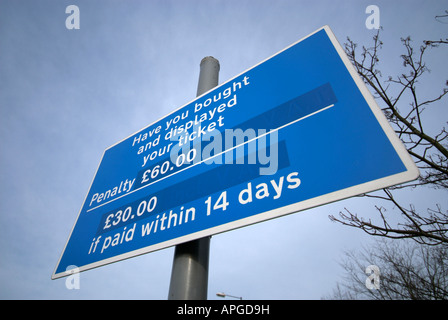 A sign with penalty payments if parkers have not bought and displayed a parking ticket. Stock Photo