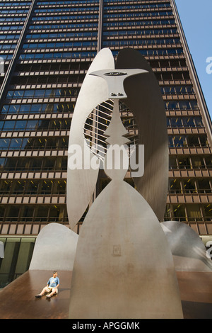 ILLINOIS Chicago Boy sitting on untitled sculpture by Pablo Picasso in Daley Plaza brown metal public art Stock Photo