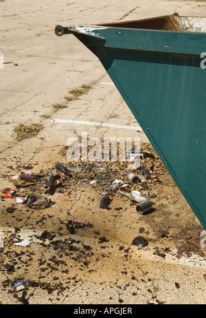 ILLINOIS Rockford Broken glass and trash on ground outside dumpster paved parking lot Stock Photo