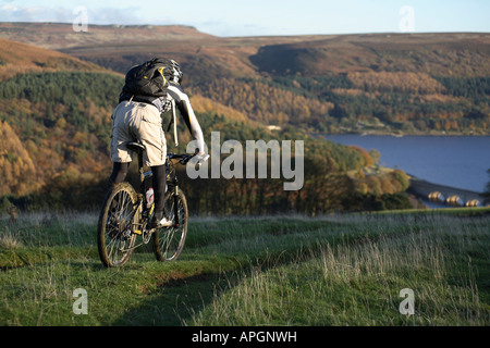 Mountain Biker rides in Peak District. England. UK Stock Photo