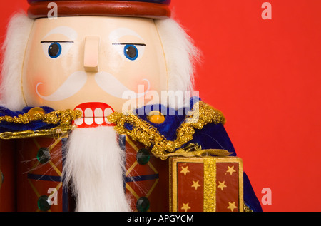 A traditional Christmas nutcracker ornament isolated on red Stock Photo