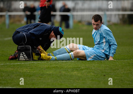 footballer receiving attention to foot injury Stock Photo