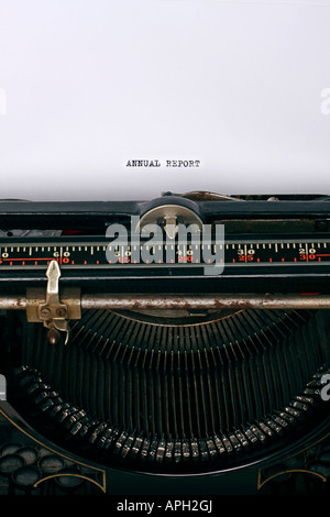 Close up of an antique typewriter with the words Annual report written on the paper main focus on letters Stock Photo