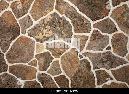 Old fashioned stone wall pattern with different sizes of stone lit with studio strobes Stock Photo
