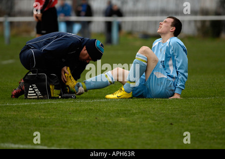 footballer receiving attention to foot injury Stock Photo