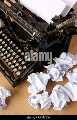 Retro typewriter with paper scattered all around conceptual image for creative block Stock Photo