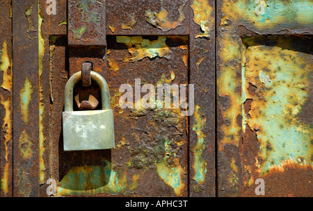 RUSTY METAL PADLOCK IN ABANDONED DOOR Stock Photo