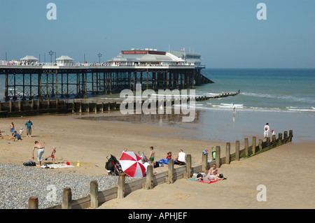 Uk, Norfolk, Cromer, people on beach with pier and Pavilion Theatre Stock Photo