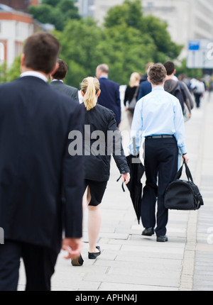 Commuters in casual business dress walk to work Stock Photo