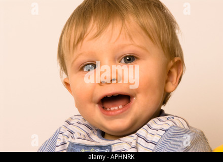 happy baby boy eleven months old smiling showing new teeth Stock Photo