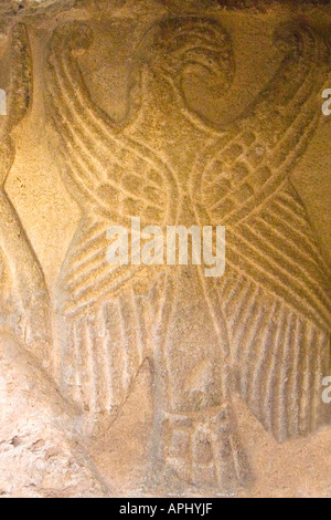 Brixworth Saxon Church interior showing roman stone carving of an eagle found in nearby roman villa near Northampton England UK Stock Photo