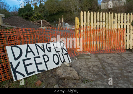 a danger "keep out" sign outside a small construction site Stock Photo