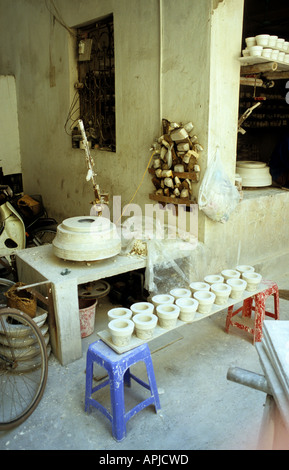 Potters wheel and clay slip moulds for making ceramic cups in a workshop, Bat Trang pottery village, Hanoi, Viet Nam Stock Photo
