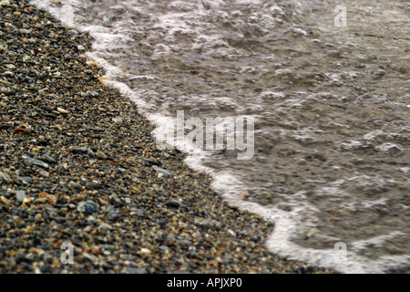 The tide coming onto the shore line Stock Photo