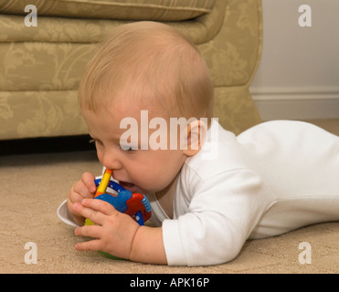 baby five months old chewing on teething rings Stock Photo
