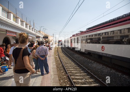 People waiting on platform for local train to arrive El Puerto de Santa Maria Spain Stock Photo