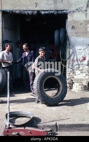 IRAQ BAGHDAD Young boy working in garage to help support his family Stock Photo